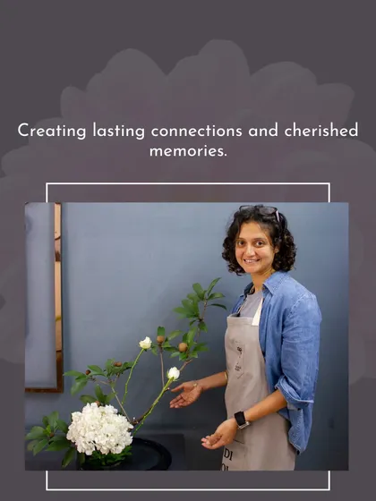A student displays her minimalist Ikebana-style arrangement, showcasing the beauty of simplicity and form.