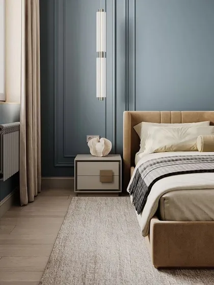 A close-up of the bedside area in a 3D-rendered bedroom. The image highlights the classic wall molding, modern pendant light, and minimalist side table.