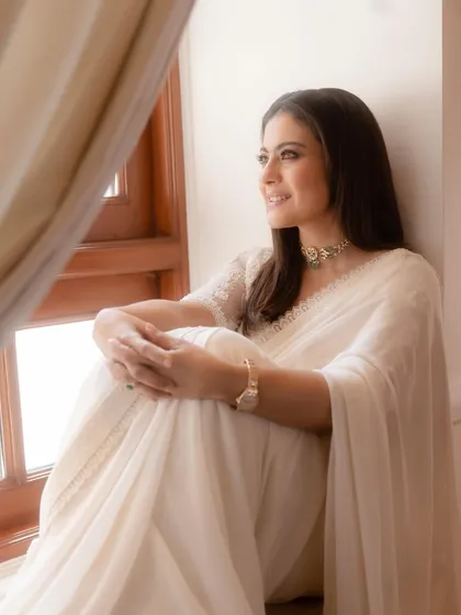 A smiling portrait that highlights the intricate details of the choker and the sheer texture of the blouse sleeves.