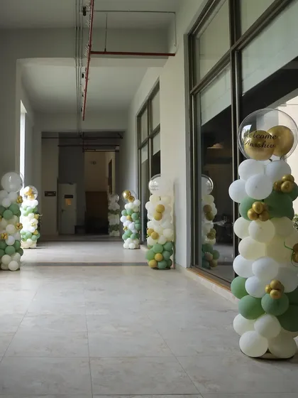Balloon pillars in the party's theme colors lined the hallway, guiding guests to the celebration.