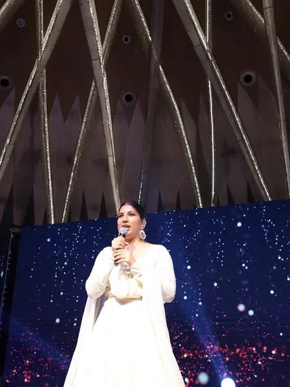 A low-angle shot capturing me against a starry backdrop at a Sangeet night. The right stage presence can make a great event feel truly epic and unforgettable.