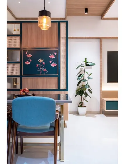 A view from the dining chair, looking towards the living room. The use of color and custom art creates a vibrant and cohesive home environment.