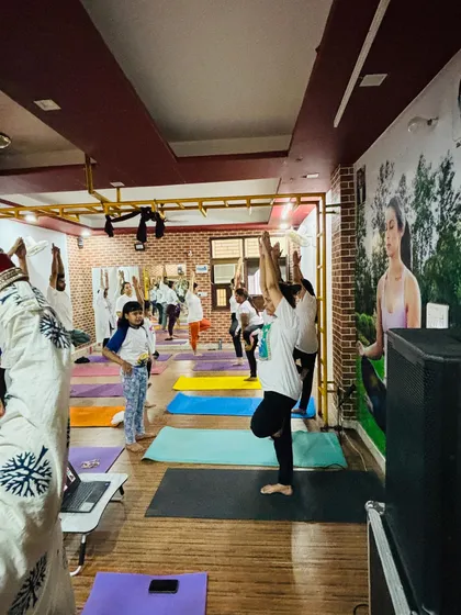 A wide shot of our shala during the International Yoga Day practice, with students of all ages participating.