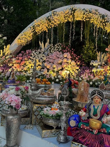 A close-up of the offering table under the illuminated floral arches.