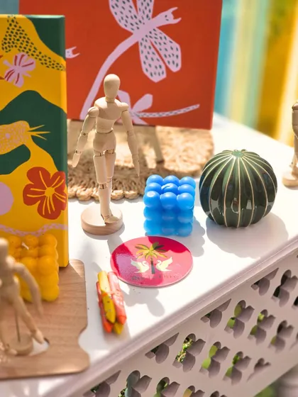 A collection of the unique, art-inspired decor items used for the Haldi, including custom-painted canvases and colorful bubble candles.