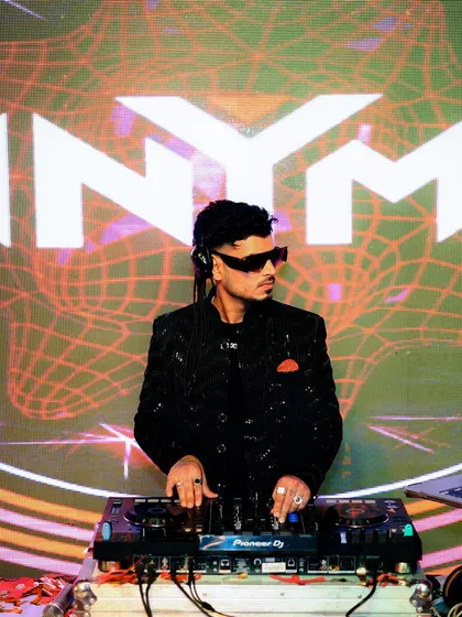Focused on the mix, with my custom visuals lighting up the background. Every detail of my performance, from the music to the visuals, is designed to create an immersive experience.