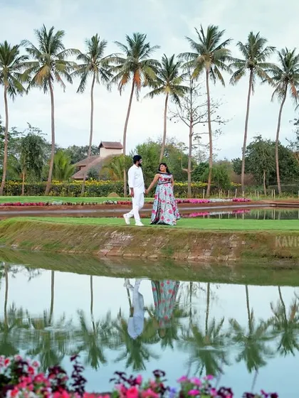 A stunning reflection shot of the couple and palm trees in the water, adding an artistic touch to their pre-wedding gallery.