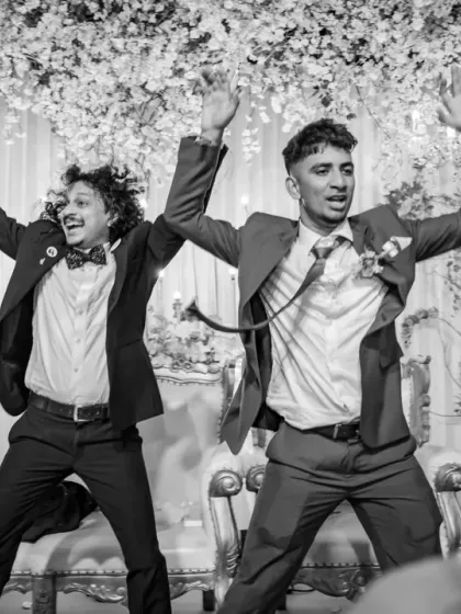 This black and white shot freezes a high-energy moment on the dance floor, showing the emcee and a guest in full party mode. The monochrome adds a timeless, dramatic feel to the action.