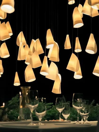 The Bocci 21 series creating an intimate and warm atmosphere for a dining setting. The light from the porcelain shades is soft and flattering, perfect for entertaining.