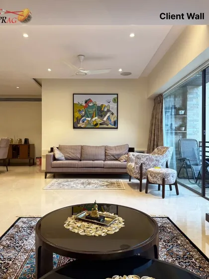 In another part of the home, a colorful 'Celebration' painting by Pradip Sarkar brings energy and rhythm to a relaxed seating area with a view.