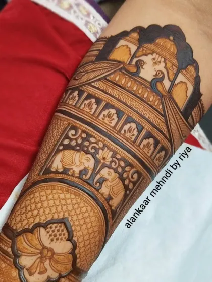 A close-up of the completed design, showcasing the rich texture and detail of the peacocks, elephants, and lotus flowers.