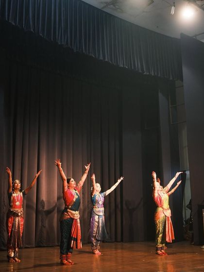 A concluding pose from one of the performances at the temple. The upward reach of their hands signifies an offering to the divine.