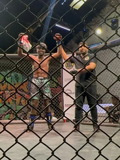 A view from behind the cage as our fighter Vishal gets his hand raised after a 30-second knockout. This is the result of countless hours of training.