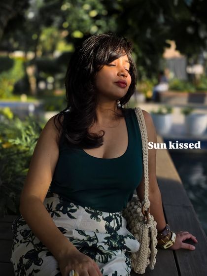 A sun-kissed moment in one of my favorite casual outfits. A simple green tank top paired with floral print pants is an easy and stylish combination for a relaxed day. This was also right after my wolf cut hair transformation!