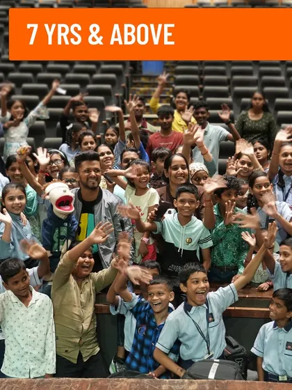 A picture with a large group of school kids, promoting my show as a perfect outing for children.