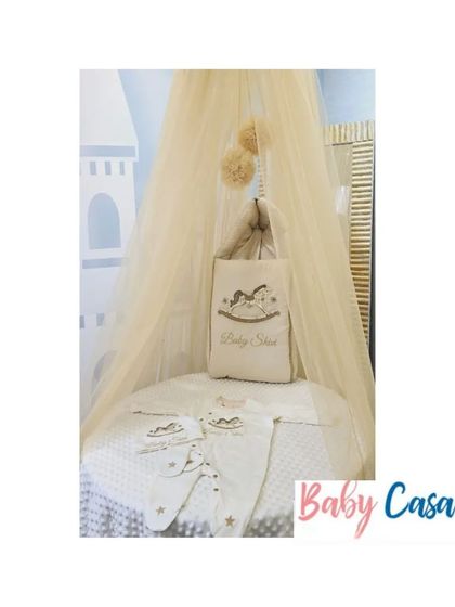 Another view of a complete nursery display. The neutral-toned rocking horse set, complete with a canopy, shows how I can create a cohesive and elegant theme for your baby's room.