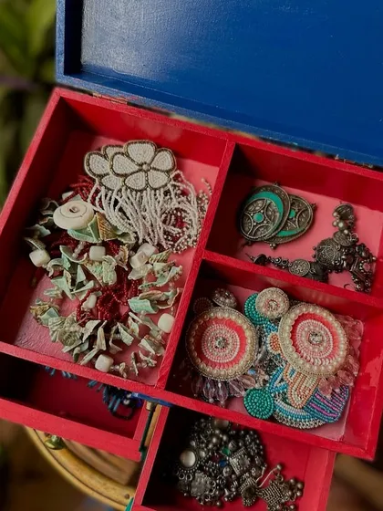 The inside of the jewelry box, with compartments to keep all her treasures organized.