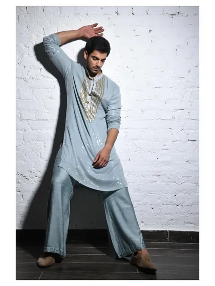 This pastel blue kurta set was styled for a summer destination wedding theme. The relaxed silhouette and subtle sequin detailing create a look that is both comfortable and elegant for men's festive wear.