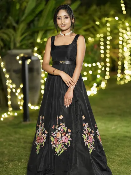 For the modern woman who loves a touch of drama, I designed this bespoke black Indo-Western gown. The fitted bodice flows into a full skirt, brought to life with vibrant, hand-embroidered floral motifs. It's a unique statement piece, ideal for a reception or cocktail evening.