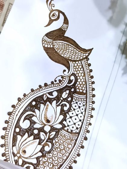 A close-up of the finished peacock and lotus design on a practice sheet. This is a great example of an advanced motif we learn.