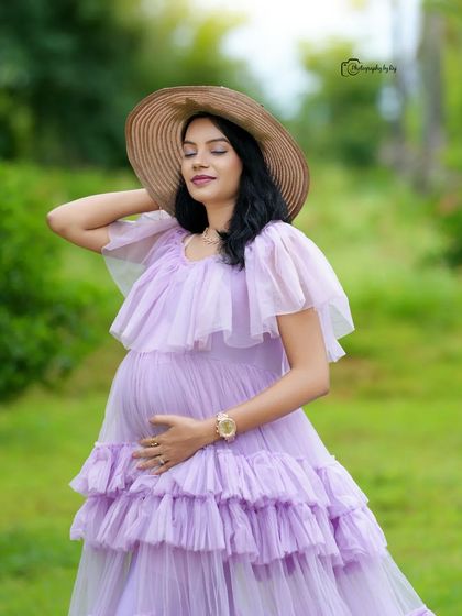 A serene solo portrait in a lavender ruffled gown and hat, enjoying the beauty of our garden.