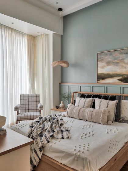 This is the overall look of a daughter's room where we incorporated the balcony to make the room feel bigger. The sage green wall, combined with wooden textures and white tones, makes the space feel both spacious and homely.