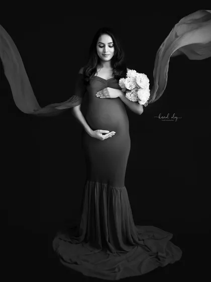 A timeless black and white version of a fine-art maternity portrait. This monochrome style emphasizes form, light, and emotion, creating a classic and powerful image.