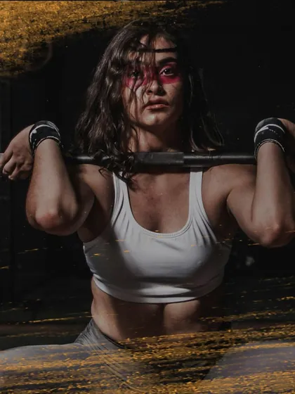 This image captures the fierce determination of a woman ready to take on a heavy lift. This is the warrior mindset we cultivate at Fittlounge.
