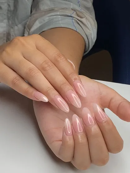 A flawless set of natural-looking, nude almond-shaped extensions. This student's work demonstrates perfect shaping and a clean, professional finish.