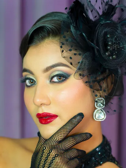 A direct, powerful portrait. The makeup is the star, with bold eyes and a striking red lip that command attention.
