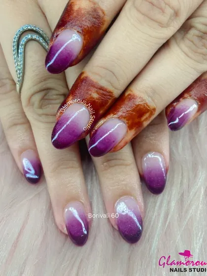 This ombré design is a client favorite for its elegance. We created a seamless gradient from a deep, rich purple at the tip to a soft, natural base, finished with a high-gloss top coat for a sophisticated and eye-catching effect.