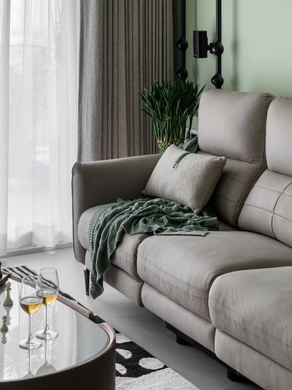 A close-up of the comfortable recliner sofa in this pastel green living room. We believe furniture should be both functional and beautiful, offering a perfect place to relax at the end of the day.
