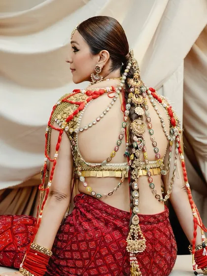 The back view highlights the incredible detail of the bride's hair and outfit. The makeup was kept clean and elegant from every angle, ensuring a cohesive and stunning bridal profile.