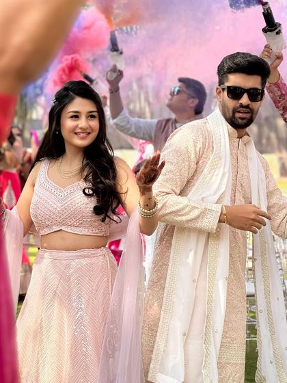 Another shot of the couple's grand entry. The bride's makeup is fresh and pretty, perfect for a daytime Haldi event.