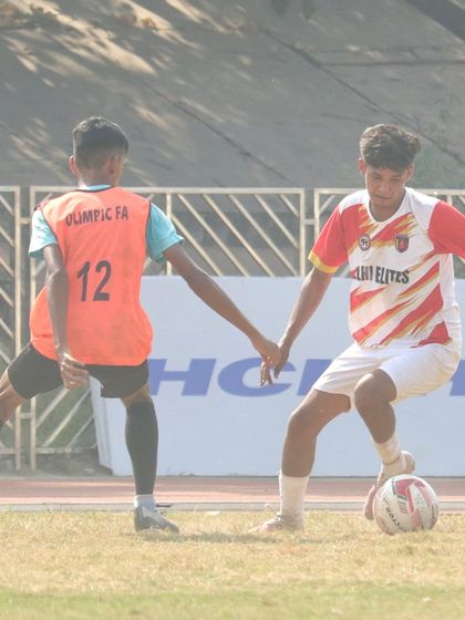 A one-on-one battle. Our player uses his body to shield the ball from a defender in a Delhi Youth League match.