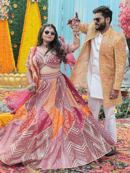The happy couple at their Haldi ceremony. The bride's makeup is fresh and radiant, a perfect match for her vibrant outfit and the joyful occasion.