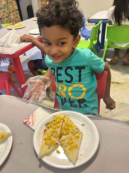 A smiling boy enjoys a healthy and tasty snack during a break at our summer camp. We ensure that even snack time is a happy experience.
