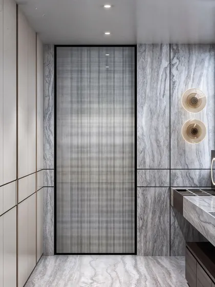 This angle highlights the custom reeded glass door and the minimalist wardrobe, creating a sleek and seamless look.