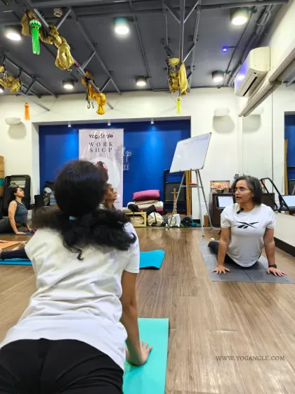 The practical component of our workshops involves moving together with awareness. Here, students practice Bhujangasana (Cobra Pose), a gentle backbend that is beneficial for spinal health and hormonal balance.