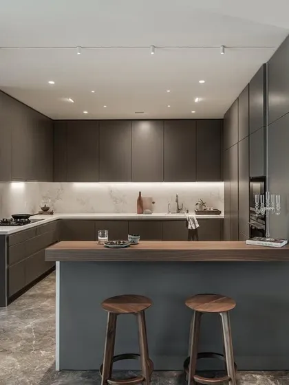 The kitchen is the heart of the home, and I design them to be both beautiful and highly functional. This open-plan kitchen features a sleek material palette, a practical layout for workflow, and integrated lighting to create a space that is perfect for both cooking and gathering.