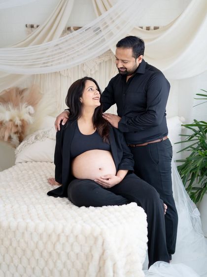 A tender moment on our studio bed setup. The partner looks lovingly at the mom-to-be as they share a quiet moment together.