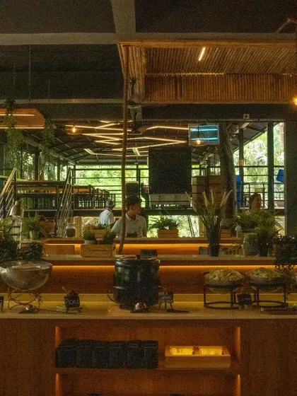 A wide view of the buffet counter, showcasing the extensive spread and the beautiful, rustic decor of the dining hall.