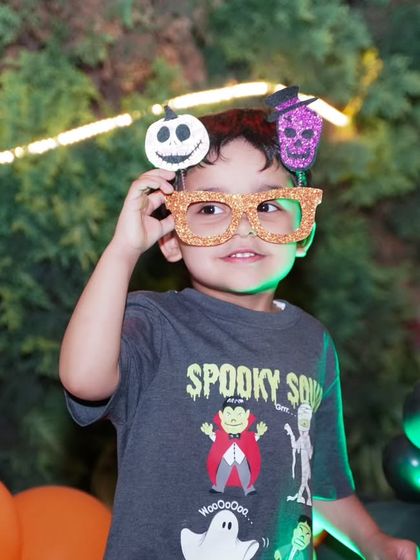 Kids just being kids. This little guest is having a blast with fun, spooky props, and we were there to capture his playful spirit during the Halloween party.
