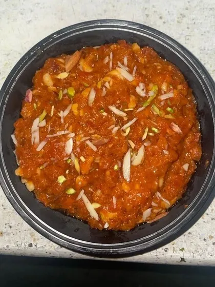 To satisfy your sweet tooth, I prepare traditional Gajar ka Halwa. It's slow-cooked to perfection and garnished with slivered almonds and pistachios for a rich, homemade dessert experience.