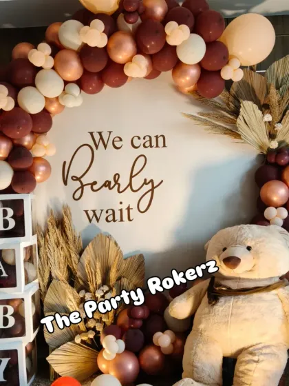 Another angle of the "We Can Bearly Wait" baby shower decor, showing the beautiful combination of the balloon arch, teddy bear, and "BABY" blocks.