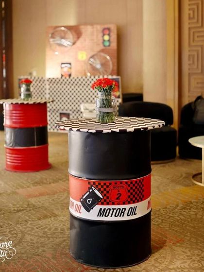 Cocktail tables for the Cars-themed party were made from painted oil drums, perfectly fitting the garage aesthetic.