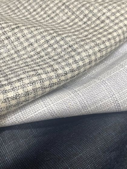 We also offer patterned linens, like these subtle checks, for those looking to add a touch of visual interest to their tailored pieces.