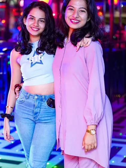 Two friends posing for a photo during a Saturday Club Night. The club is a place to make memories.