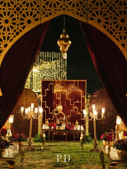 The entrance to a Sufi Sangeet, designed to feel like stepping into a royal, mystical courtyard. We used velvet drapes, intricate jaali arches, and warm candlelight to create an opulent and soulful atmosphere.