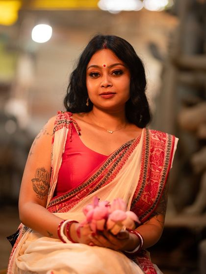 Embracing the divine spirit of Durga Puja. This look, created for a shoot in a sculptor's studio, features classic Bengali makeup with defined eyes and a red bindi.
